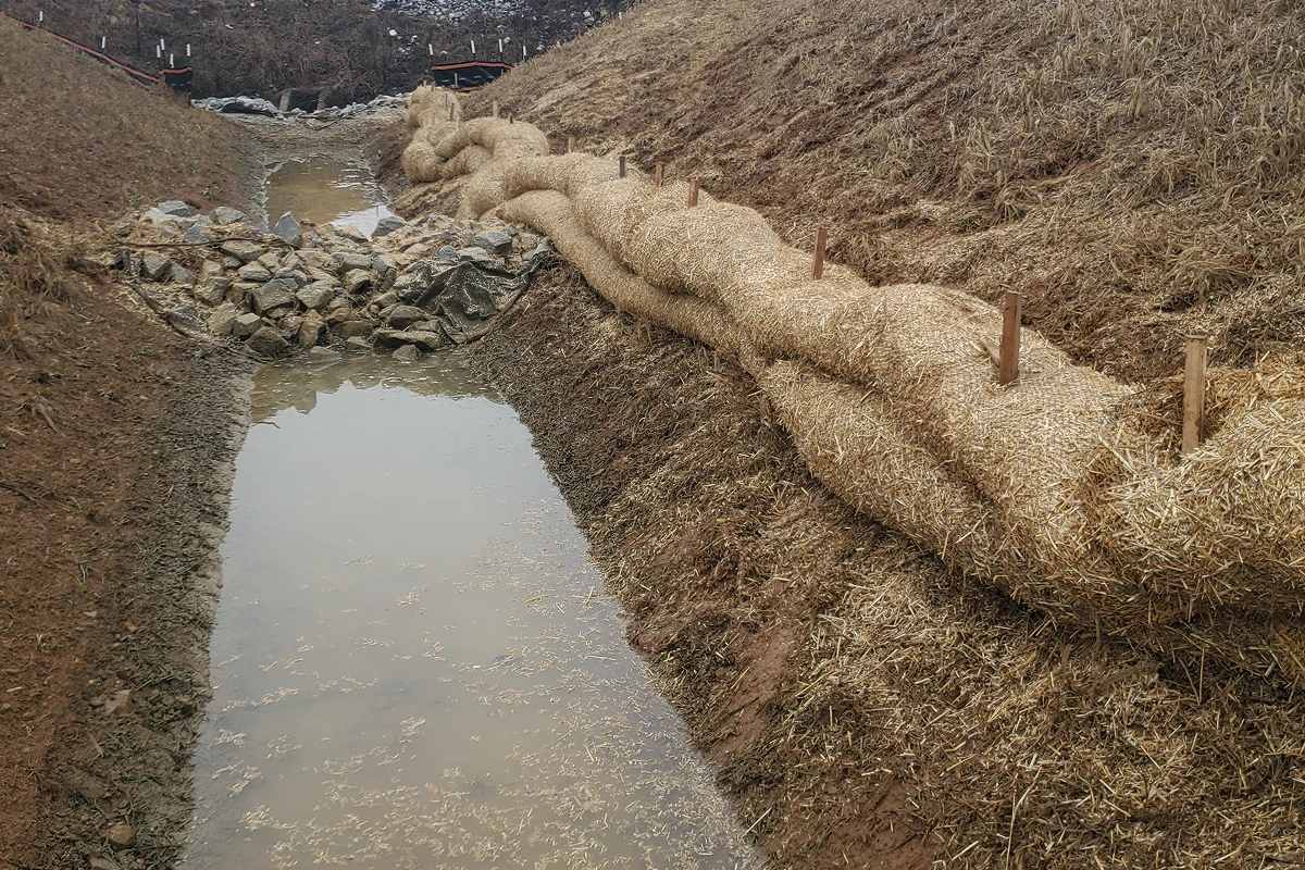 Watercourse with straw barriers